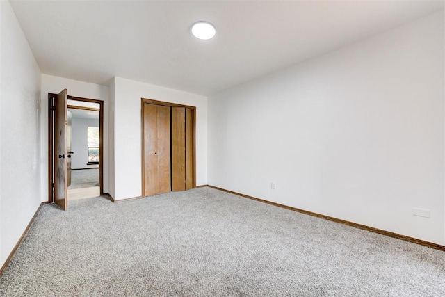 unfurnished bedroom with carpet floors and a closet