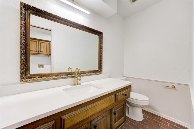 900 Woodbury Dr, Edmond, OK 73034 - bathroom featuring vanity and brick patterned floors