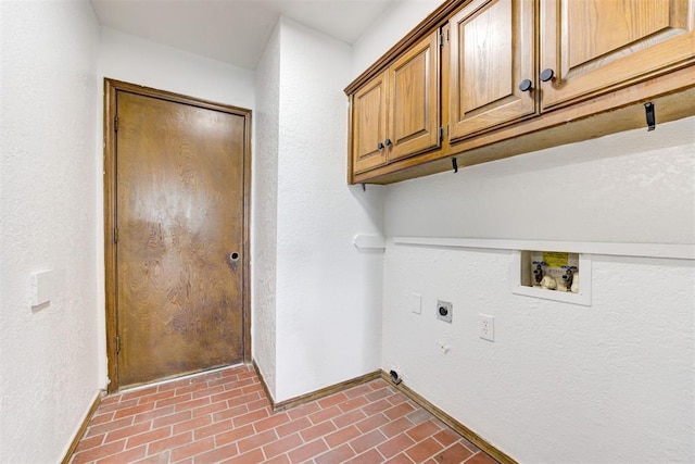 900 Woodbury Dr, Edmond, OK 73034 - laundry room with hookup for an electric dryer, cabinet space, brick patterned floors, hookup for a washing machine, and a textured wall