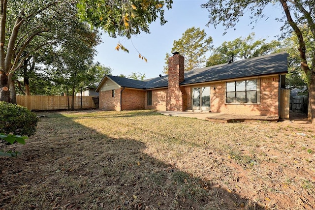 back of property featuring a lawn