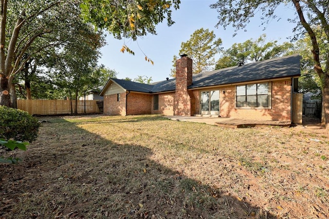 900 Woodbury Dr, Edmond, OK 73034 - back of property with a chimney and brick siding