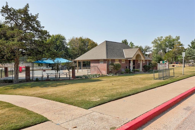 900 Woodbury Dr, Edmond, OK 73034 - view of home's exterior featuring brick siding and roof with shingles