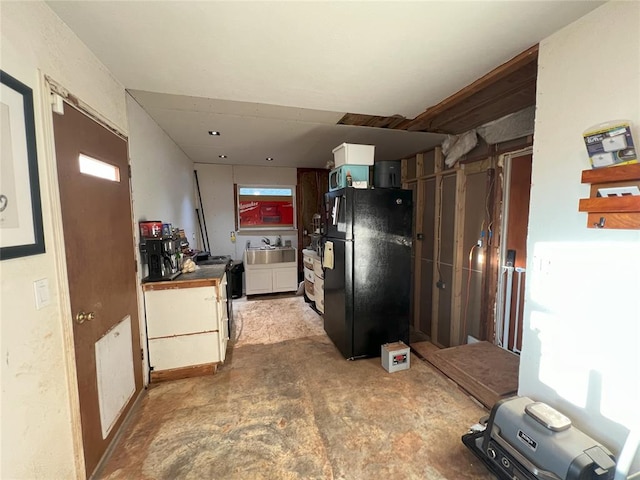 kitchen featuring black appliances, white cabinets, and sink