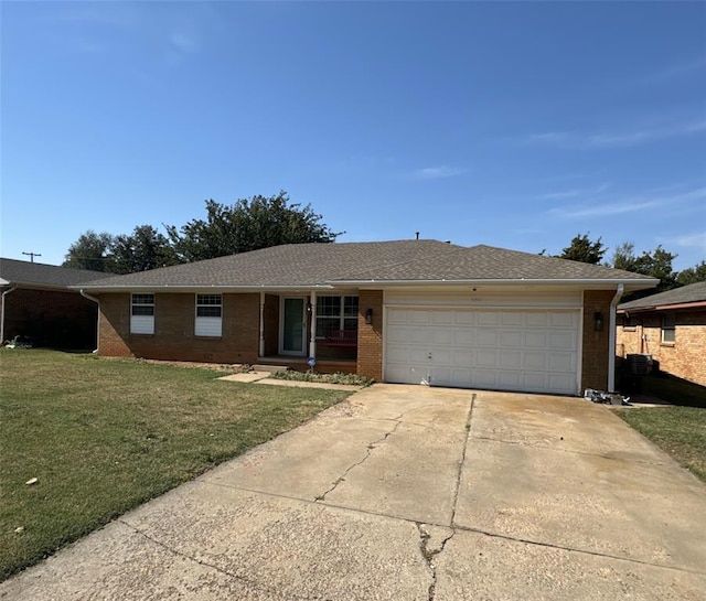 ranch-style home with a front lawn and a garage