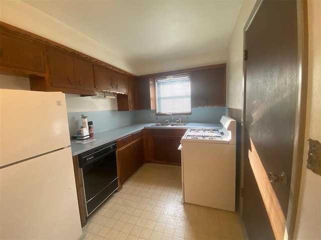 kitchen with sink, white fridge, stove, and black dishwasher