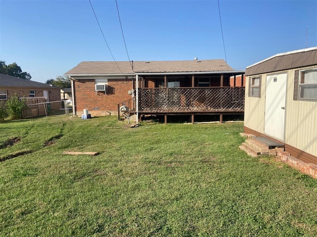 rear view of property featuring a storage unit and a yard