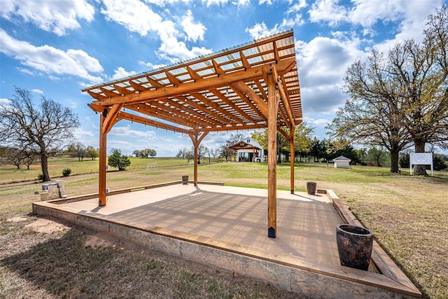 view of patio / terrace with a pergola and a shed