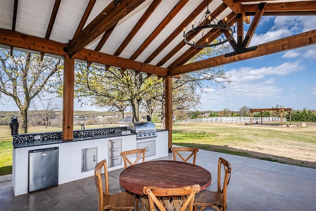 view of patio featuring a rural view, area for grilling, and a grill