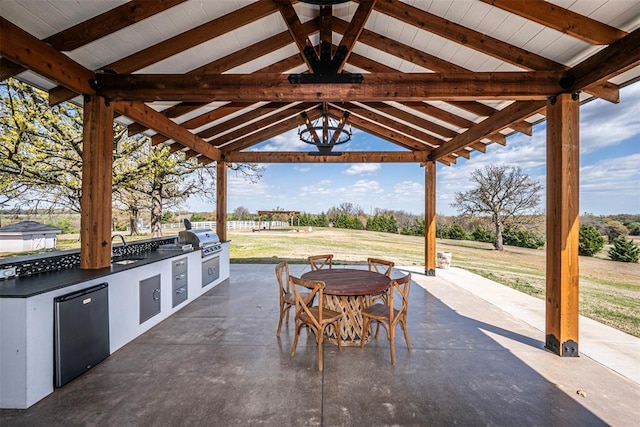 view of patio featuring a gazebo, area for grilling, and exterior kitchen