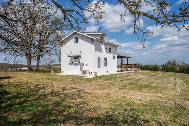 rear view of house featuring a yard