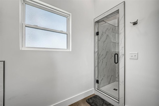 bathroom with a shower with door