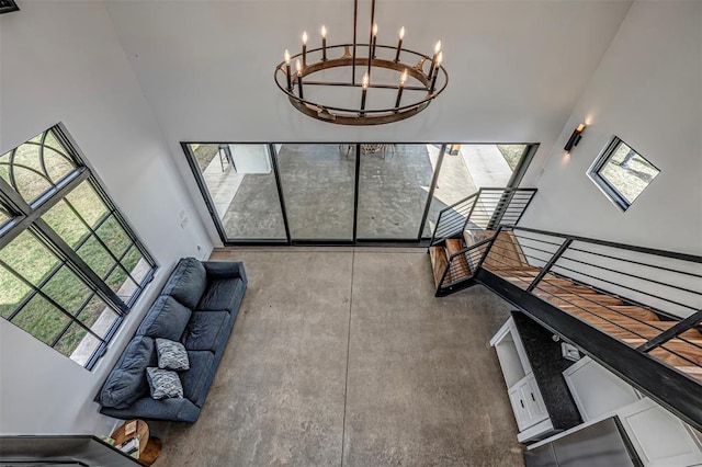 living room with a high ceiling and a notable chandelier