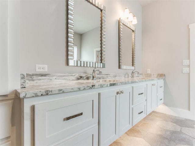 bathroom with tile patterned flooring and vanity