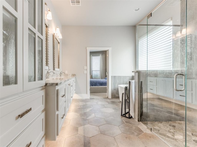 bathroom featuring vanity and an enclosed shower