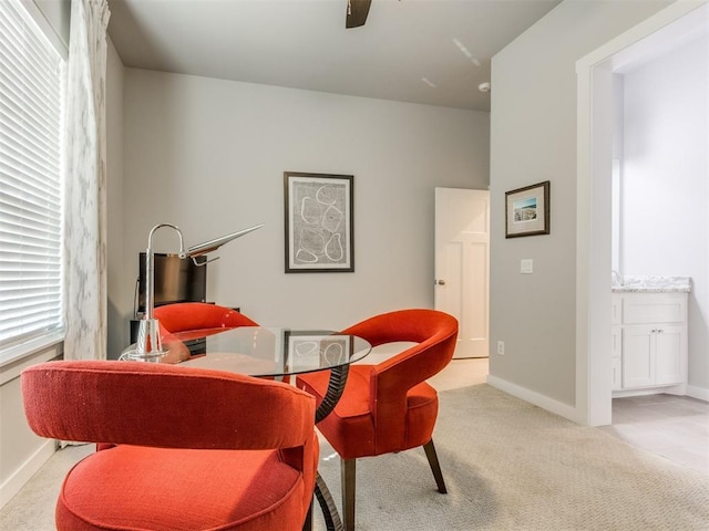 living area with ceiling fan and light colored carpet