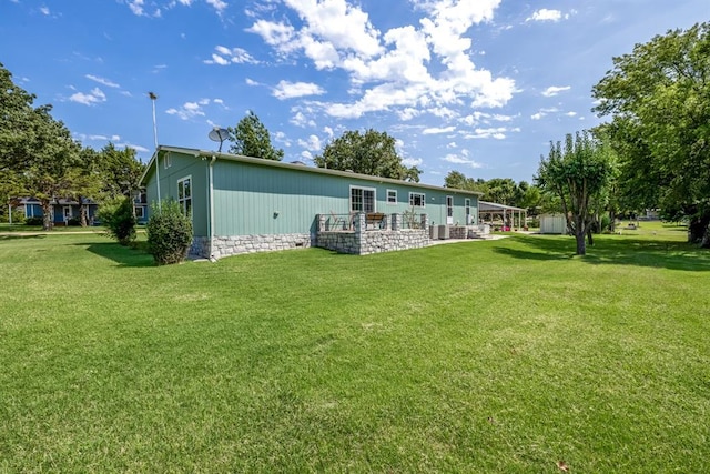 back of property featuring a lawn