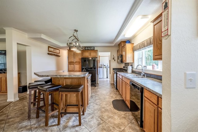 kitchen featuring pendant lighting, a center island, black appliances, sink, and ornamental molding