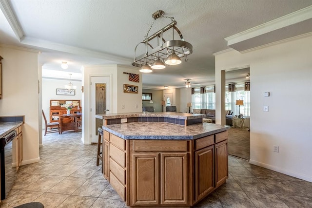 kitchen featuring dishwasher, a center island, ornamental molding, and hanging light fixtures