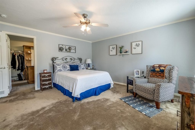 bedroom featuring a walk in closet, a closet, ceiling fan, and ornamental molding