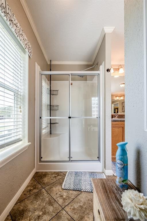 bathroom featuring tile patterned floors, a wealth of natural light, walk in shower, and ornamental molding