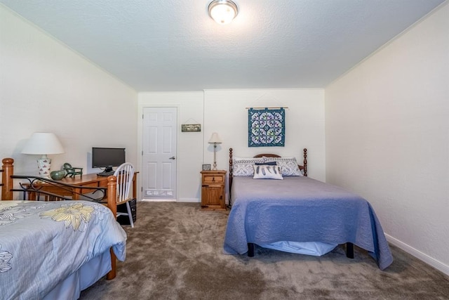 bedroom with dark colored carpet and a textured ceiling