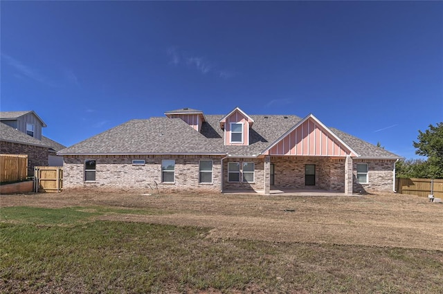 rear view of property with a yard and a patio