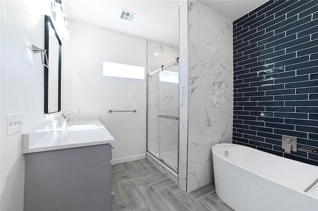 bathroom with vanity and separate shower and tub