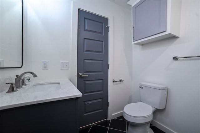 bathroom featuring tile patterned flooring, vanity, and toilet