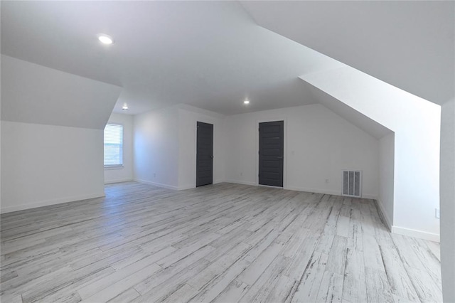 bonus room featuring light hardwood / wood-style floors and vaulted ceiling