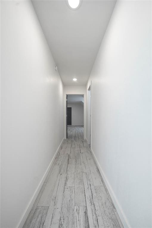 corridor with light hardwood / wood-style flooring