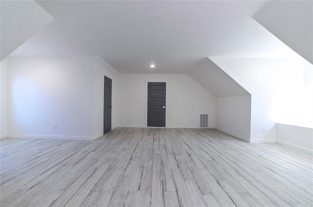 bonus room featuring light hardwood / wood-style floors and vaulted ceiling