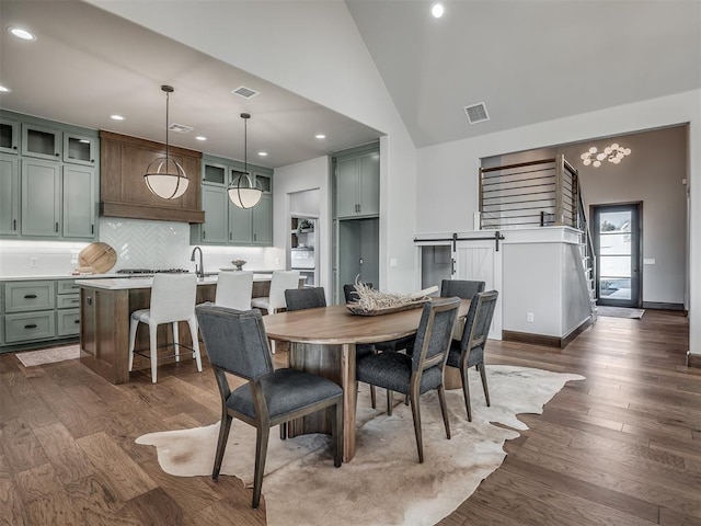 dining area featuring visible vents, recessed lighting, high vaulted ceiling, and dark wood-type flooring