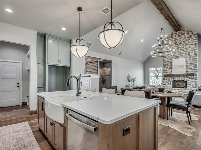 kitchen featuring light stone countertops, stainless steel dishwasher, dark wood-style flooring, and vaulted ceiling with beams