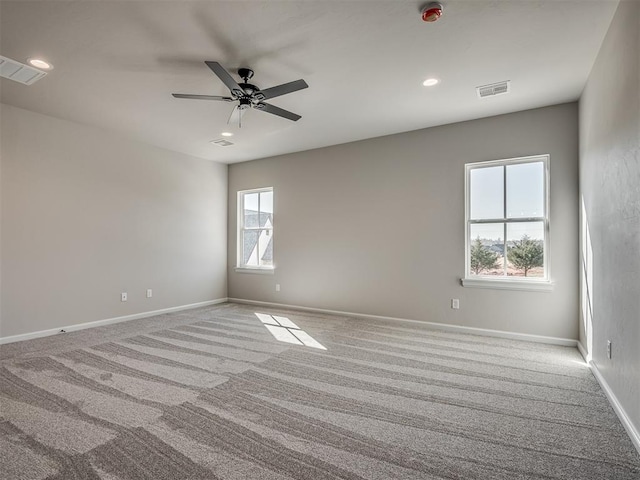 unfurnished room featuring visible vents, baseboards, and carpet flooring