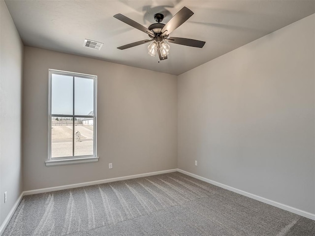 empty room featuring visible vents, baseboards, a ceiling fan, and carpet flooring