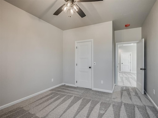 unfurnished bedroom with carpet flooring, ceiling fan, and baseboards