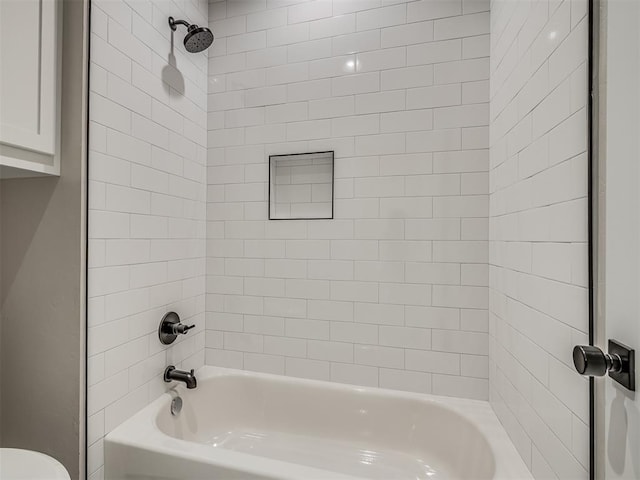 bathroom featuring toilet and bathing tub / shower combination