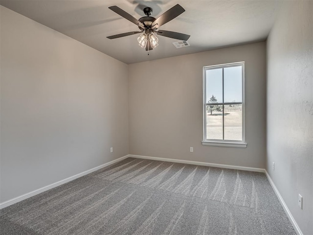 spare room with visible vents, carpet, baseboards, and ceiling fan