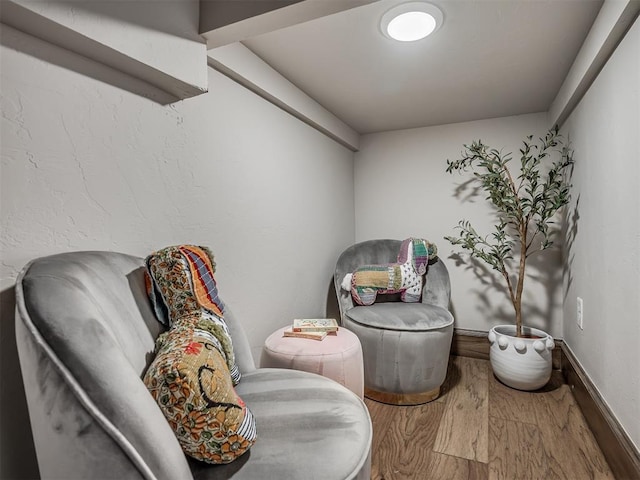 sitting room featuring baseboards and wood finished floors