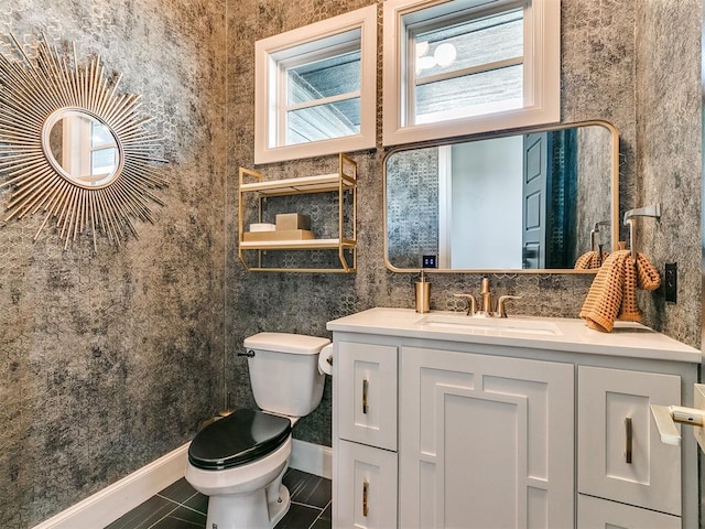 bathroom with tile patterned floors, vanity, toilet, and plenty of natural light