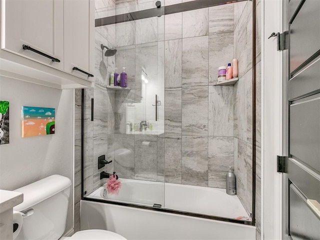 bathroom featuring shower / bath combination with glass door and toilet