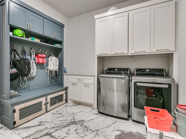 laundry room with cabinets and washer and dryer