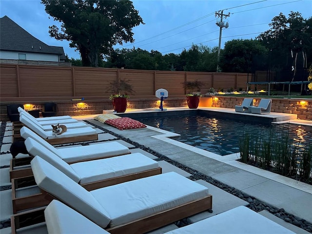 view of pool featuring a trampoline and a patio