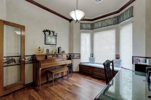 office area with a healthy amount of sunlight, hardwood / wood-style flooring, and crown molding