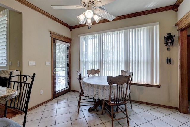 tiled dining room featuring a wealth of natural light, crown molding, and ceiling fan