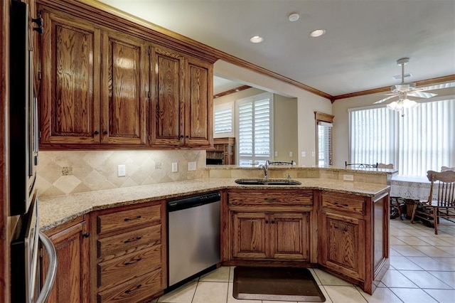 kitchen with a healthy amount of sunlight, kitchen peninsula, sink, and appliances with stainless steel finishes