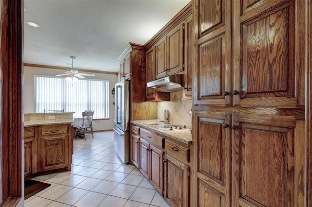 kitchen with decorative backsplash, stainless steel fridge, light tile patterned floors, and white gas cooktop