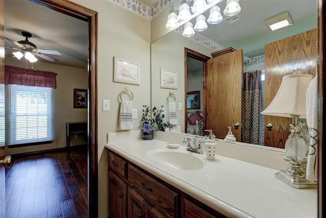 bathroom with wood-type flooring, vanity, and ceiling fan