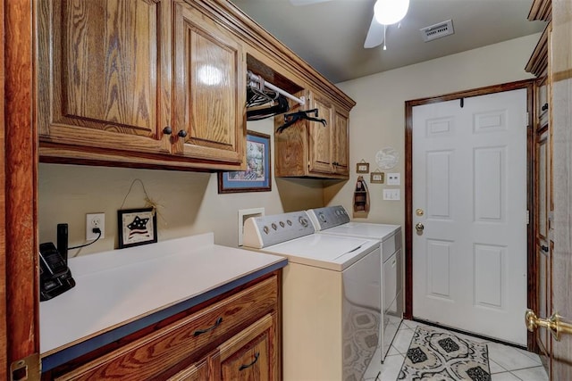 clothes washing area with cabinets, light tile patterned floors, washer and clothes dryer, and ceiling fan