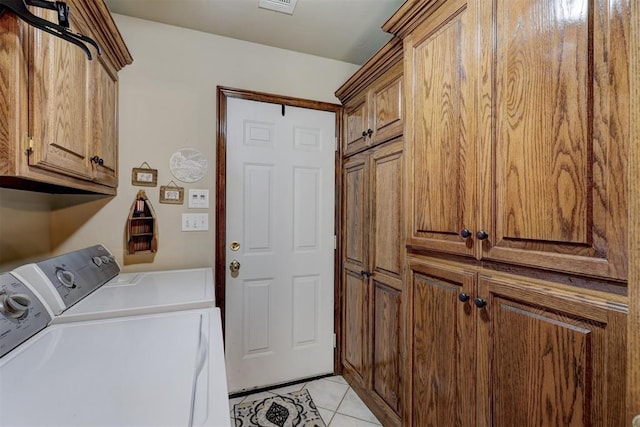 washroom featuring cabinets, independent washer and dryer, and light tile patterned floors